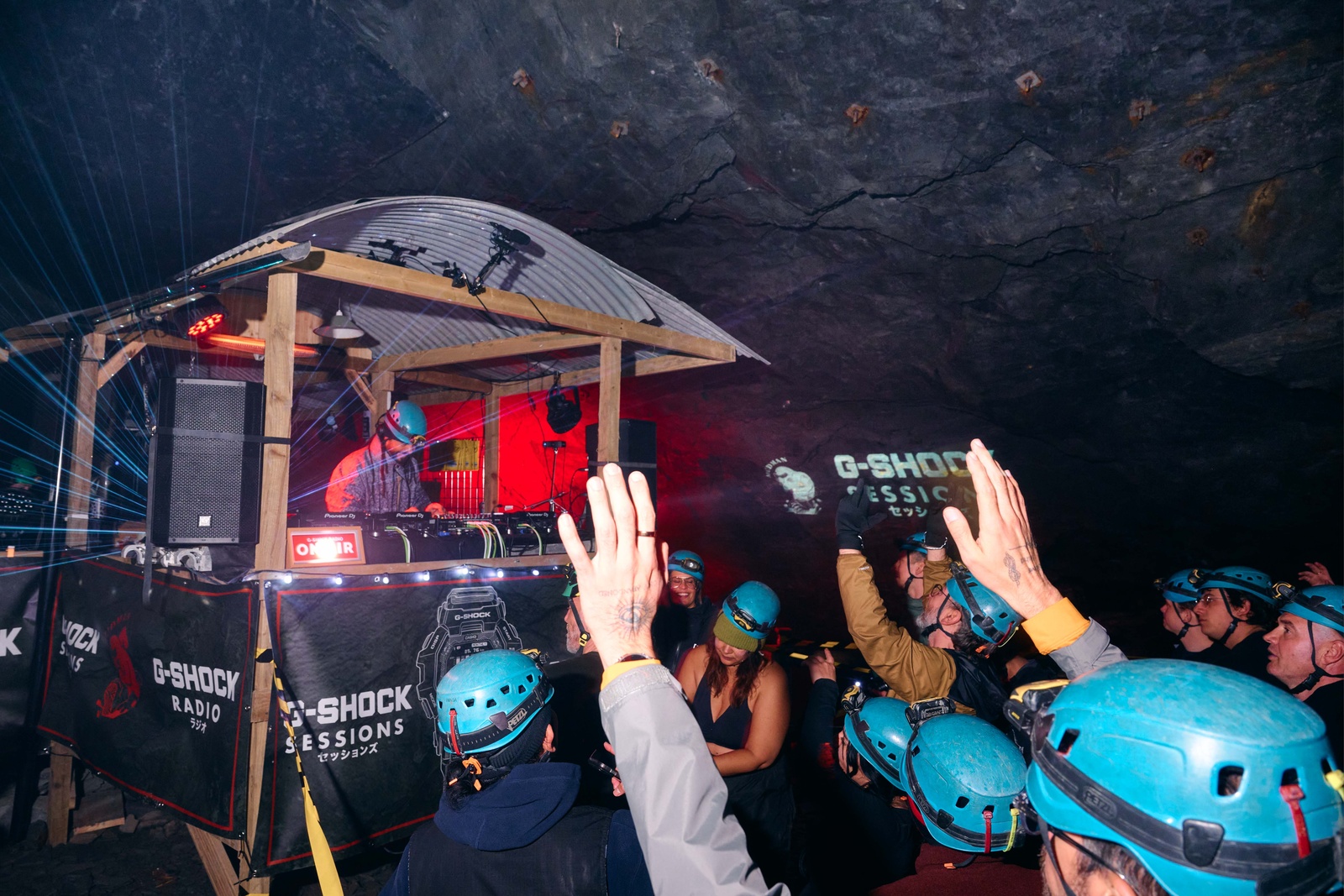 The DJ booth in the chamber, G-SHOCK Sessions banners and the crowd in helmets.