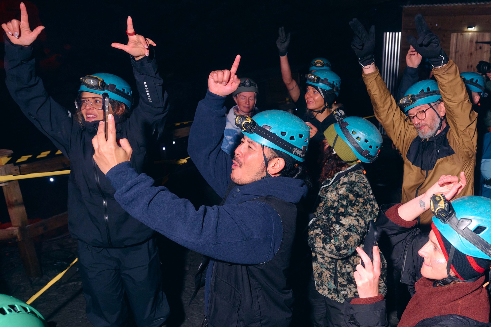 Ravers in helmets, hands up.